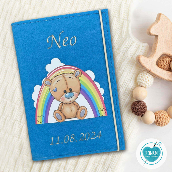 Designbeispiel der U-Heft Hülle blau Teddy mit Regenbogen für Jungs